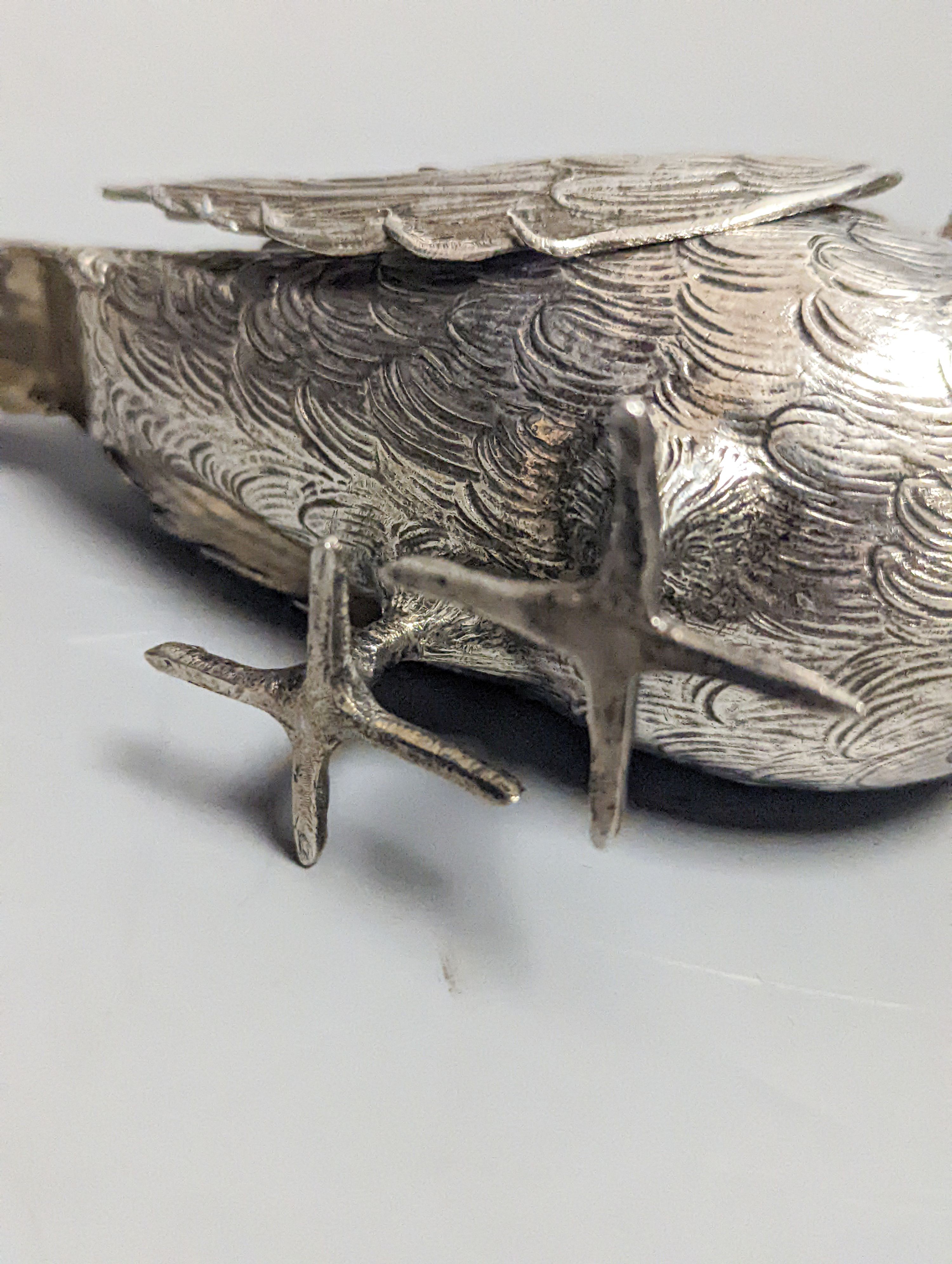 A late 19th century Hanau 800 white metal novelty condiment?, modelled as a game bird, with articulated wings and removable head, 22.4cm, gross 139 grams.